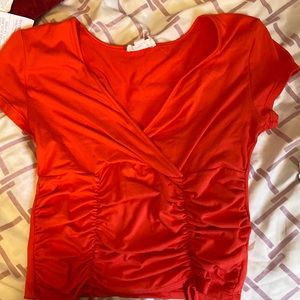Glitz size of shirt is small color of shirt orange